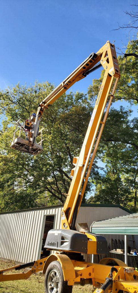 Trimming Maple Tree with lift by house in Charleston, WV