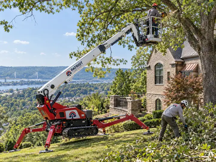 Illustration of a tracked spider lift reaching a tree canopy beside a house on a hillside.